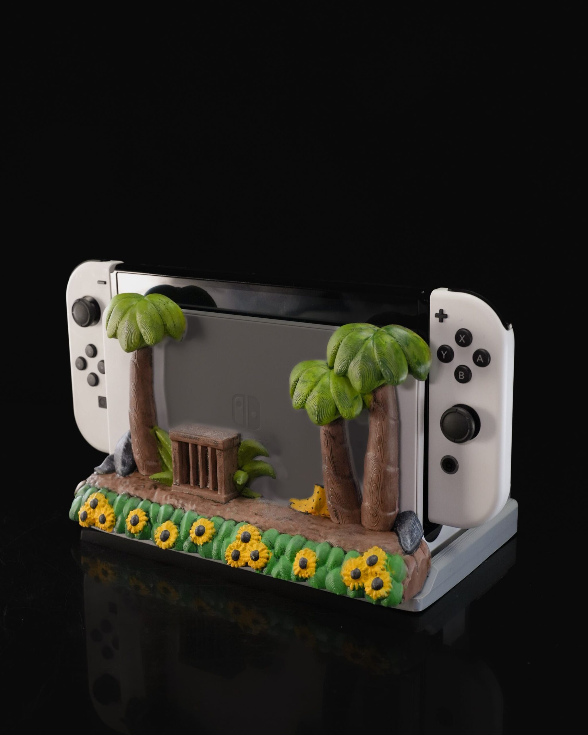 A 3D printed Nintendo Switch dock diorama with tropical trees, flowers, and a wooden path in a 3D Printed Project Gallery display.