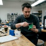 Engineer comparing PLA PETG ABS parts in lab