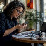Designer inspecting personalized 3D printed miniature