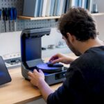 Technician scanning small mechanical part