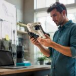 Engineer inspecting 3D printed prototype in lab