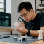 Engineer inspecting 3D printed object closely