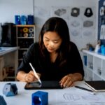Designer sketching prototype goals at drafting table