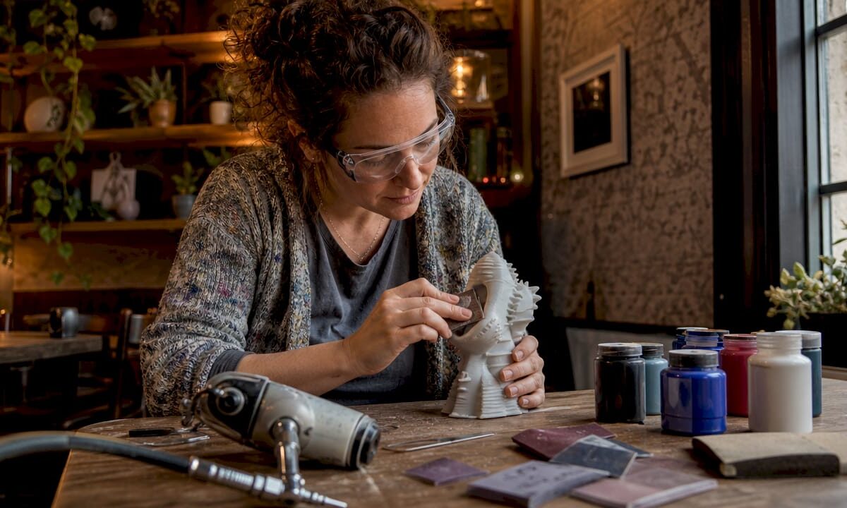 Artist sanding 3D printed sculpture