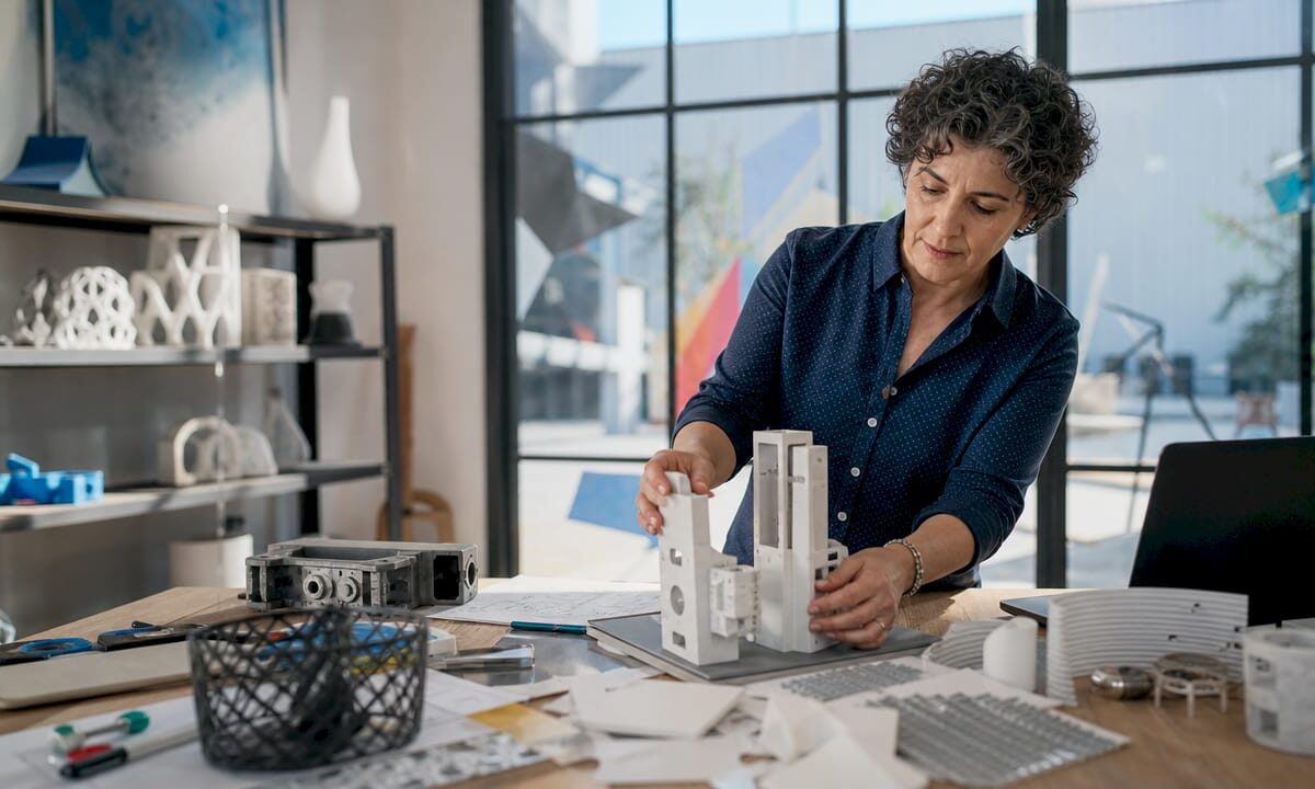 Female engineer reviewing 3D CAD model on monitor