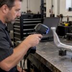 Technician scanning a cast-aluminum automotive shift lever
